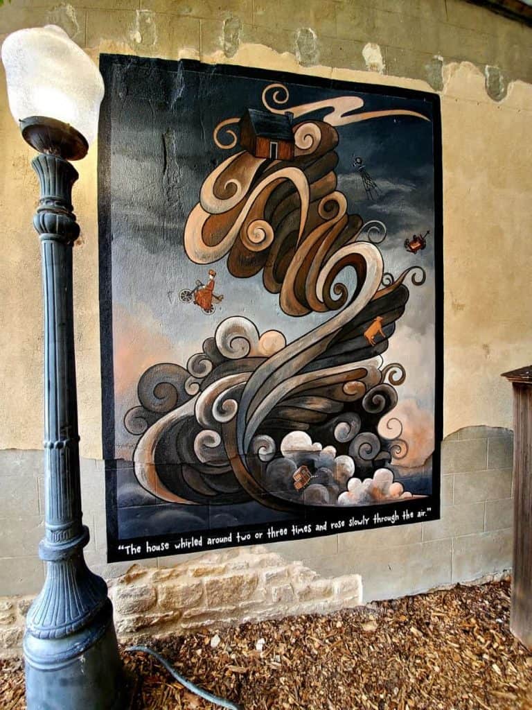 Mural of Auntie Em's home being hit by the tornado on the Yellow Brick Rd.