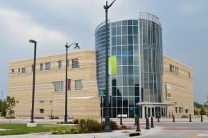 Modern glass-fronted building with stone facade.