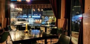 Cozy cafe interior with street view at night.