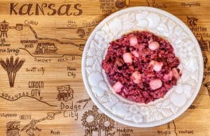 Plate of fruit salad on engraved Kansas map table.