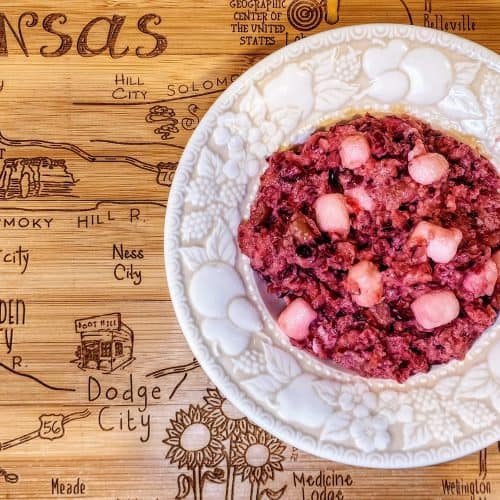 Plate of fruit salad on engraved Kansas map table.