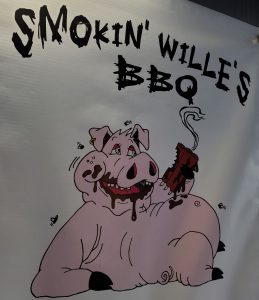 A sign that says smokin' willie's bbq.