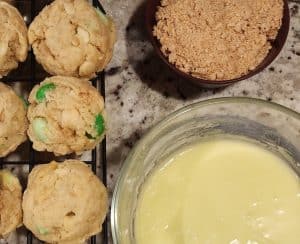 A bowl of cookies and a bowl of icing.