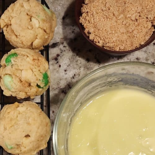 A bowl of cookies and a bowl of icing.