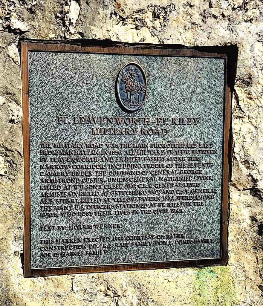 A plaque on the side of a stone wall.