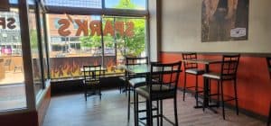 The inside of a restaurant with tables and chairs.