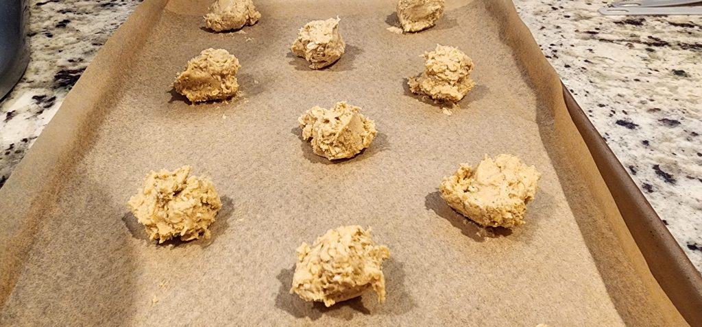 The cookies are sitting on a baking sheet.