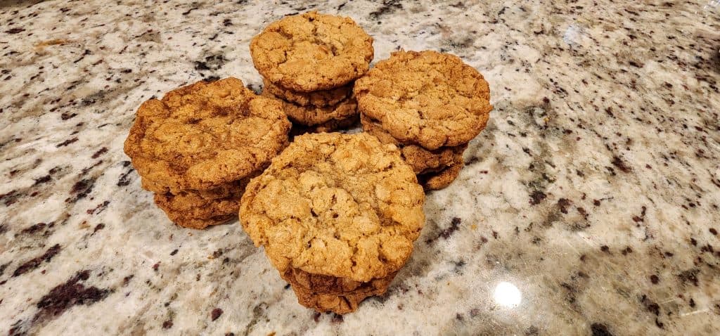 A group of oatmeal cookies on a granite counter.