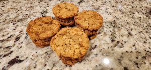 A group of oatmeal cookies on a granite counter.