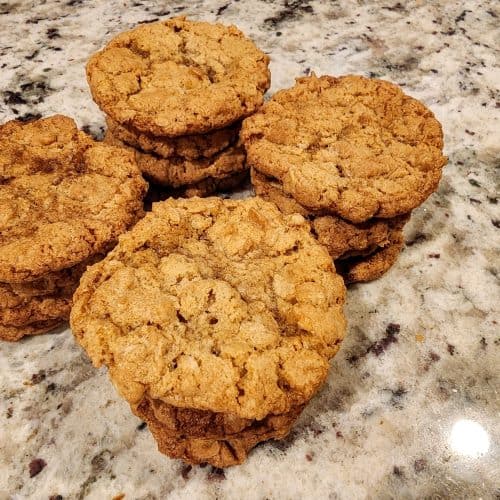 A group of oatmeal cookies on a granite counter.