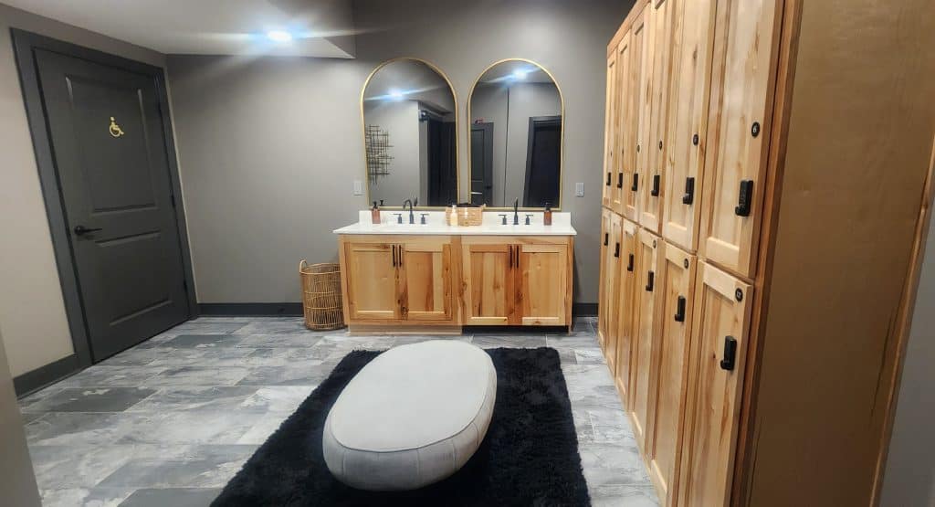 A bathroom with wooden cabinets and mirrors.