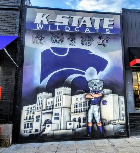 A mural of a kansas state wildcats football player on the side of a building.