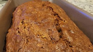 A loaf of banana bread sitting in a pan.