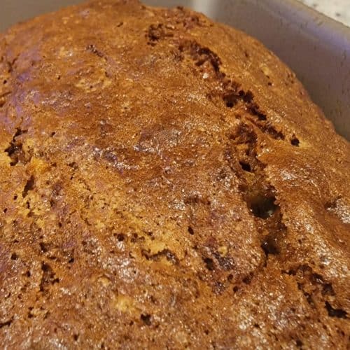 A loaf of banana bread sitting in a pan.
