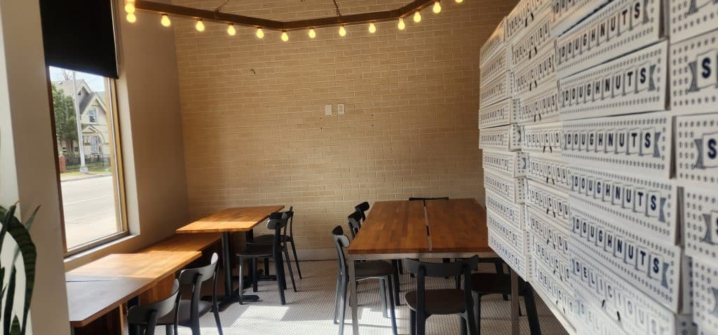 The inside of a restaurant with tables and chairs.