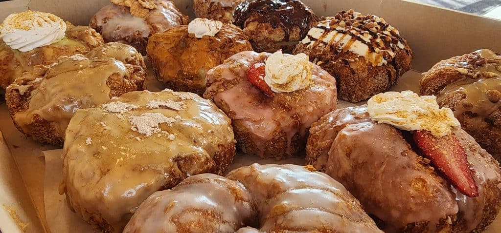 A box of donuts with frosting and icing.