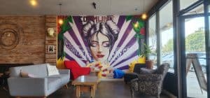 A coffee shop with a mural on the wall.
