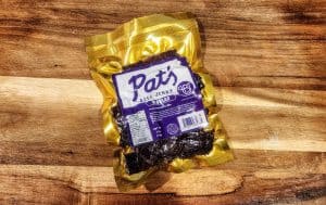 Packaged beef jerky on wooden surface.