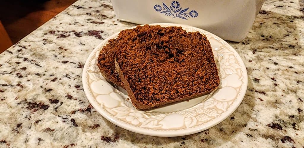 Slice of chocolate cake on patterned plate.