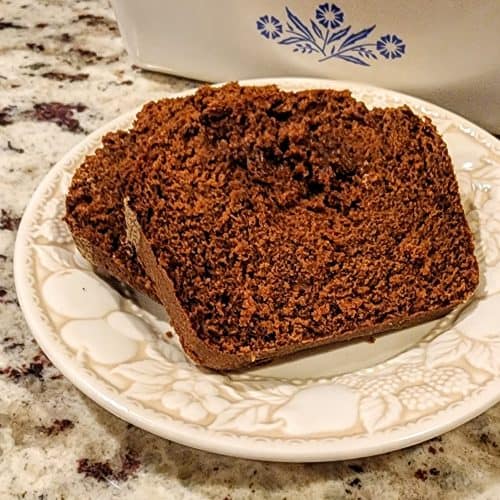 Slice of chocolate cake on patterned plate.