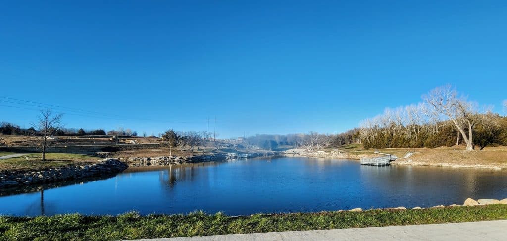 Serene riverside landscape with clear blue sky.