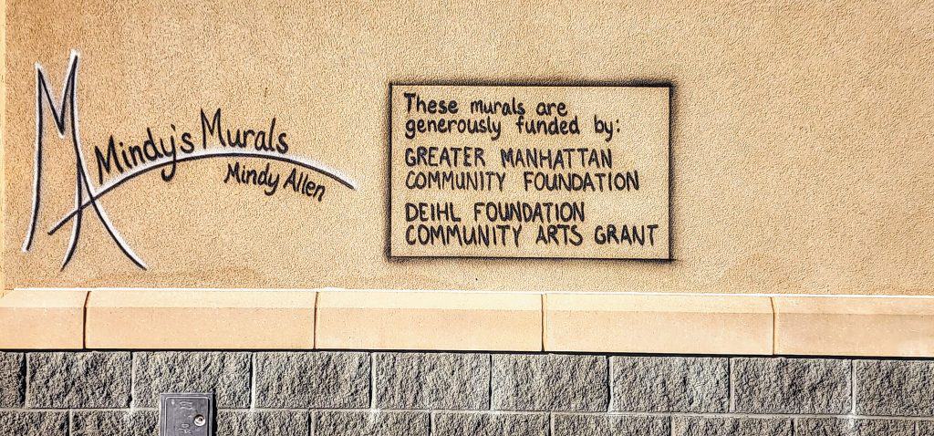Plaque crediting donors for funding community murals.