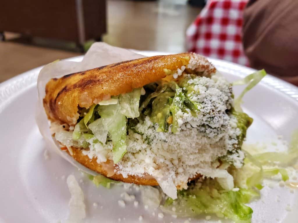 A sandwich with lettuce and cheese on a plate at Taqueria El Aguila in Manhattan, KS.