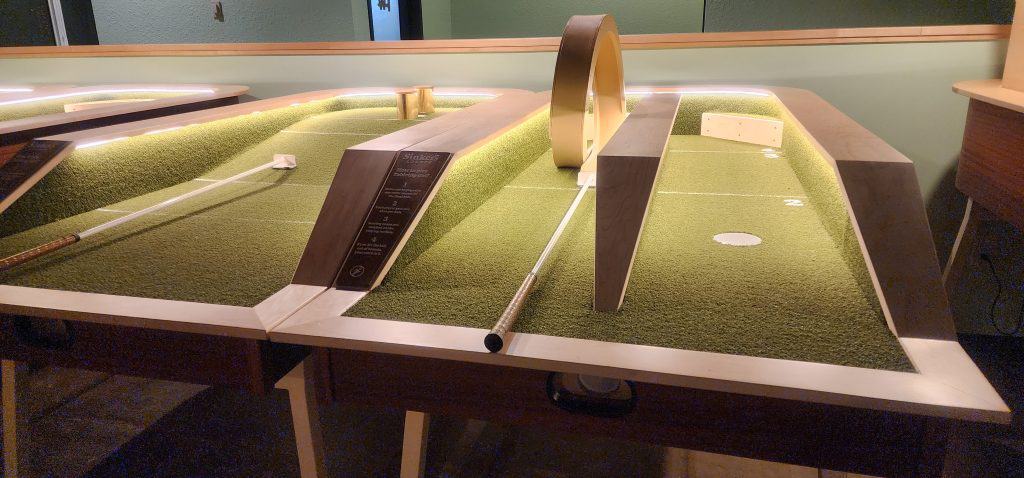 The Sinkers Lounge in Manhattan, KS offers a cozy room filled with a group of ping pong tables.