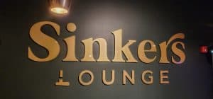 A sinker's lounge sign on a wall in Manhattan, KS.
