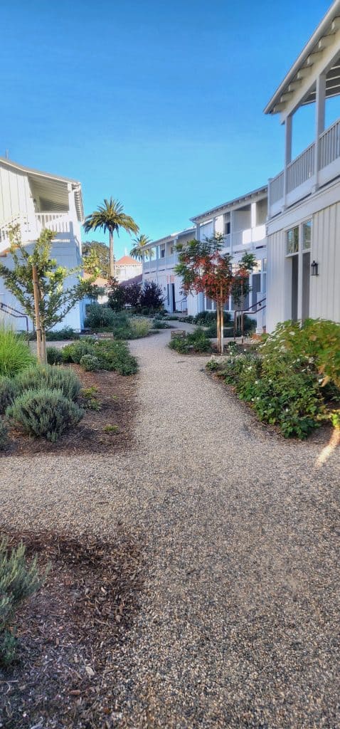 A pathway leading to an apartment complex.