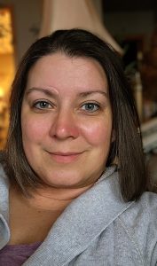 A woman is taking a selfie in a living room after receiving a diagnosis.