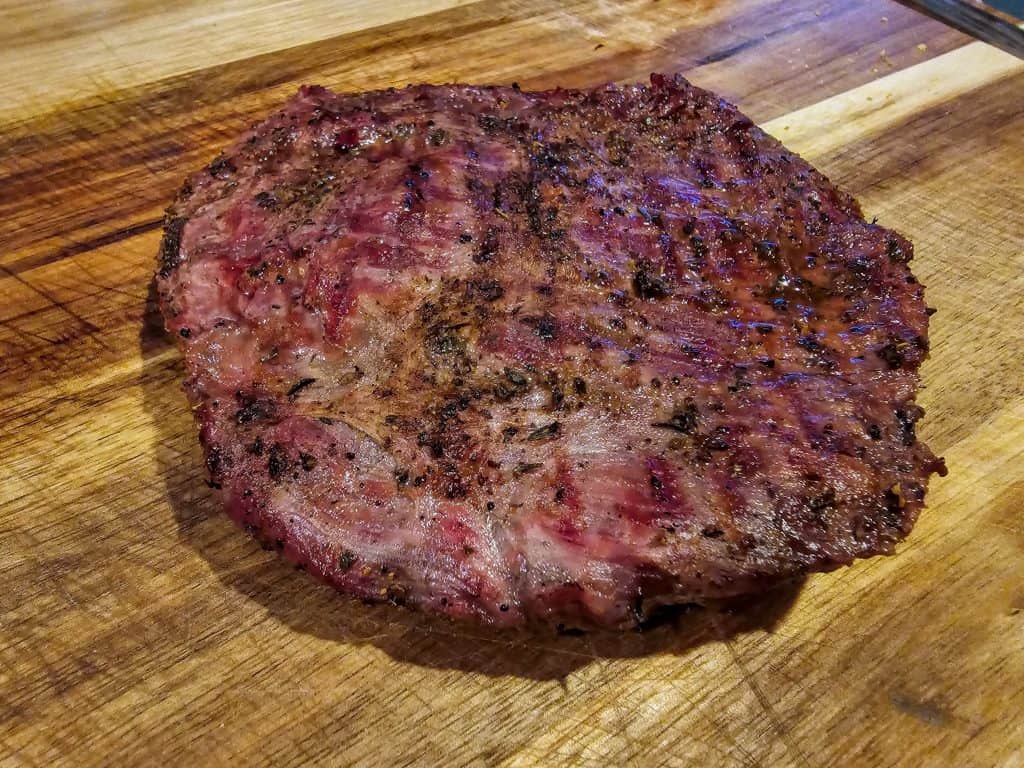 A Bison steak on a wooden cutting board from Flint Hills Bison Company, Manhattan KS.