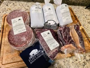 A cutting board with a variety of Flint Hills Bison meats on it.