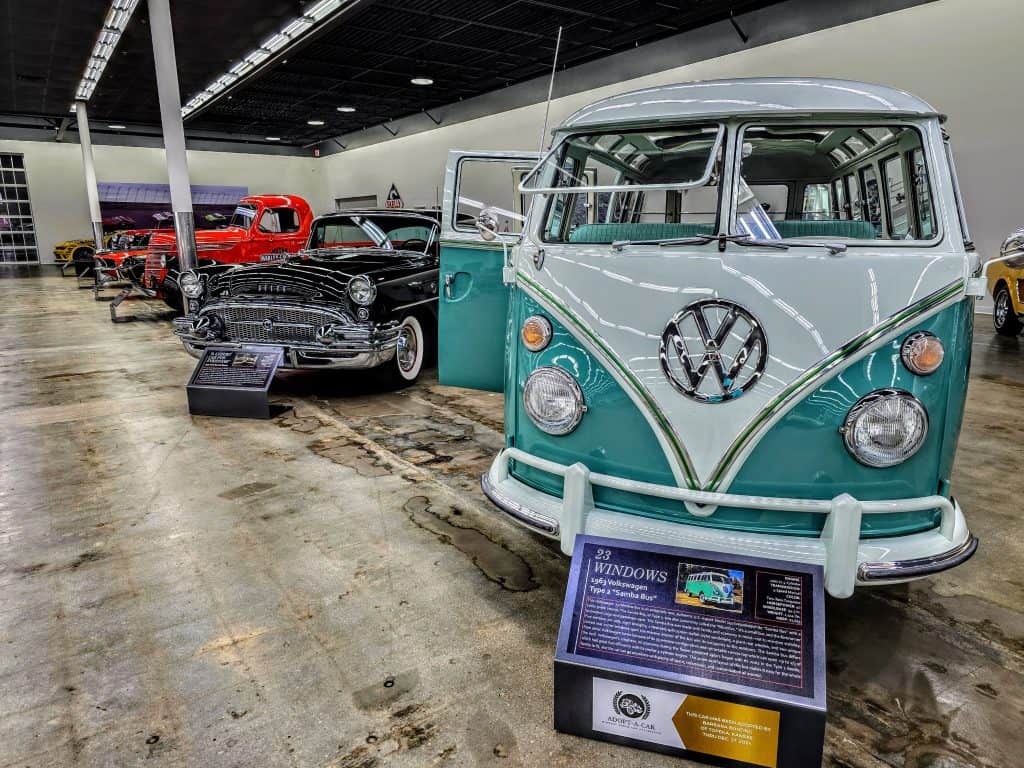 A group of cars in a car museum.