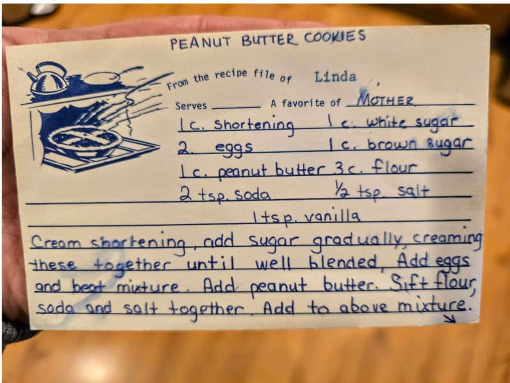 A handwritten recipe titled "Peanut Butter Cookies" lists ingredients and steps. Ingredients include shortening, eggs, peanut butter, sugars, flour, baking soda, salt, and vanilla. Steps describe creaming shortening and sugar, adding eggs and dry ingredients, and mixing.